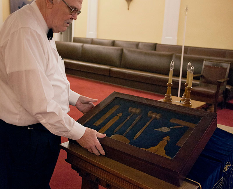 An older gentleman shows off historical artifacts in the main lodge